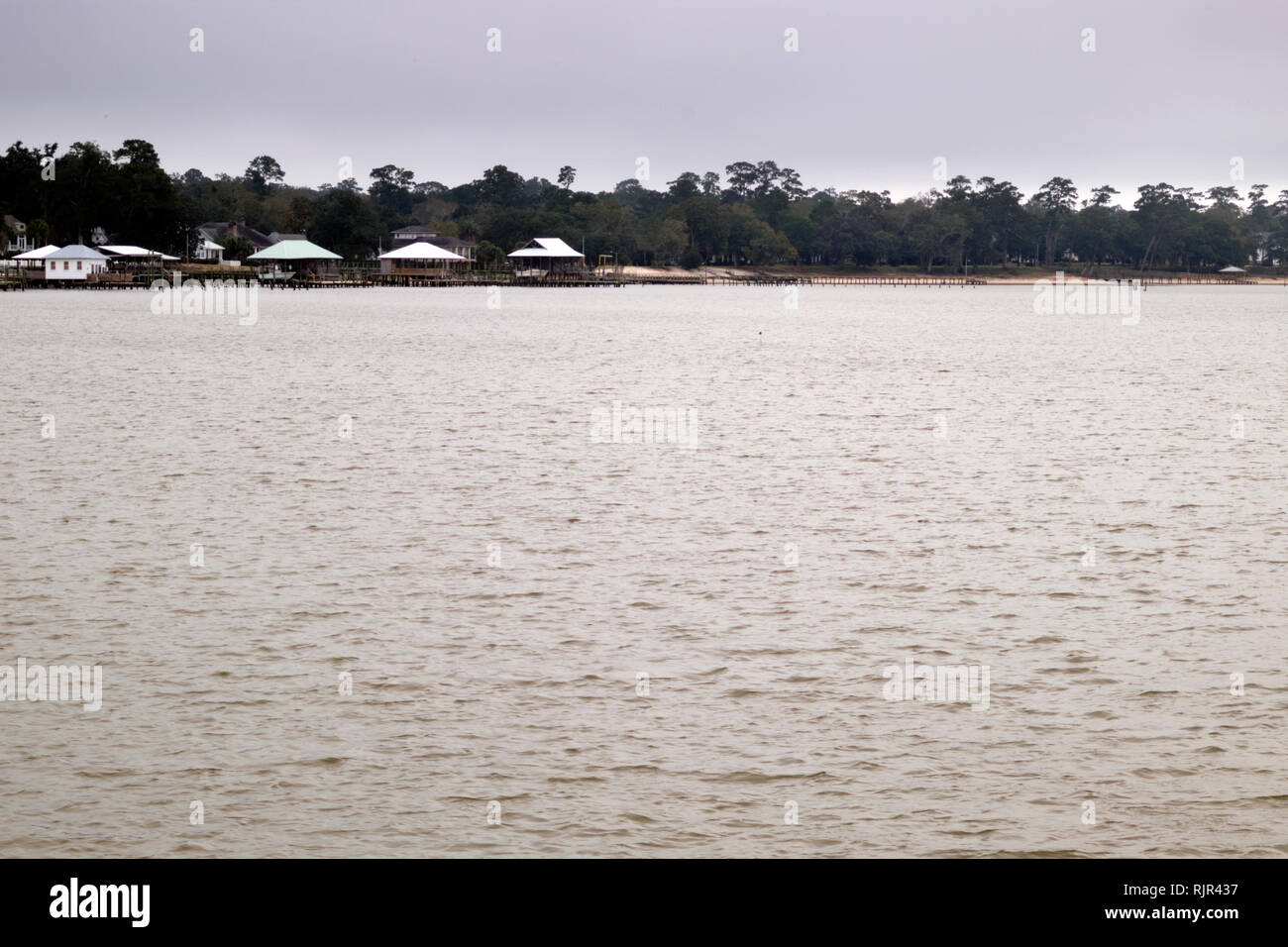 The east shore of Mobile Bay taken from the pier at Fairhope, Alabama on a dreary winter day in February. Stock Photo