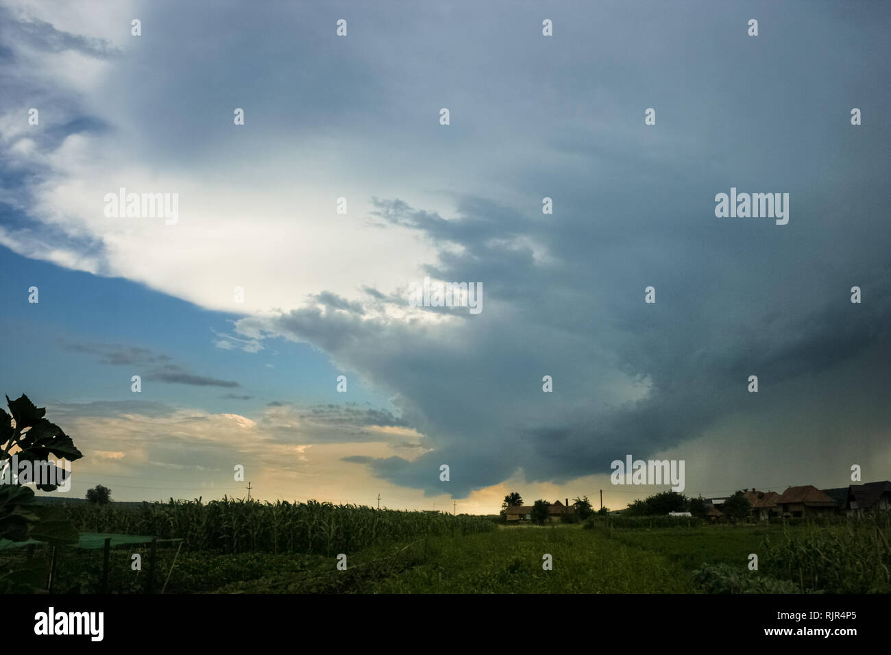 Wall cloud, rain shaft and anvil of a supercell thunderstorm in the central part of Romania Stock Photo