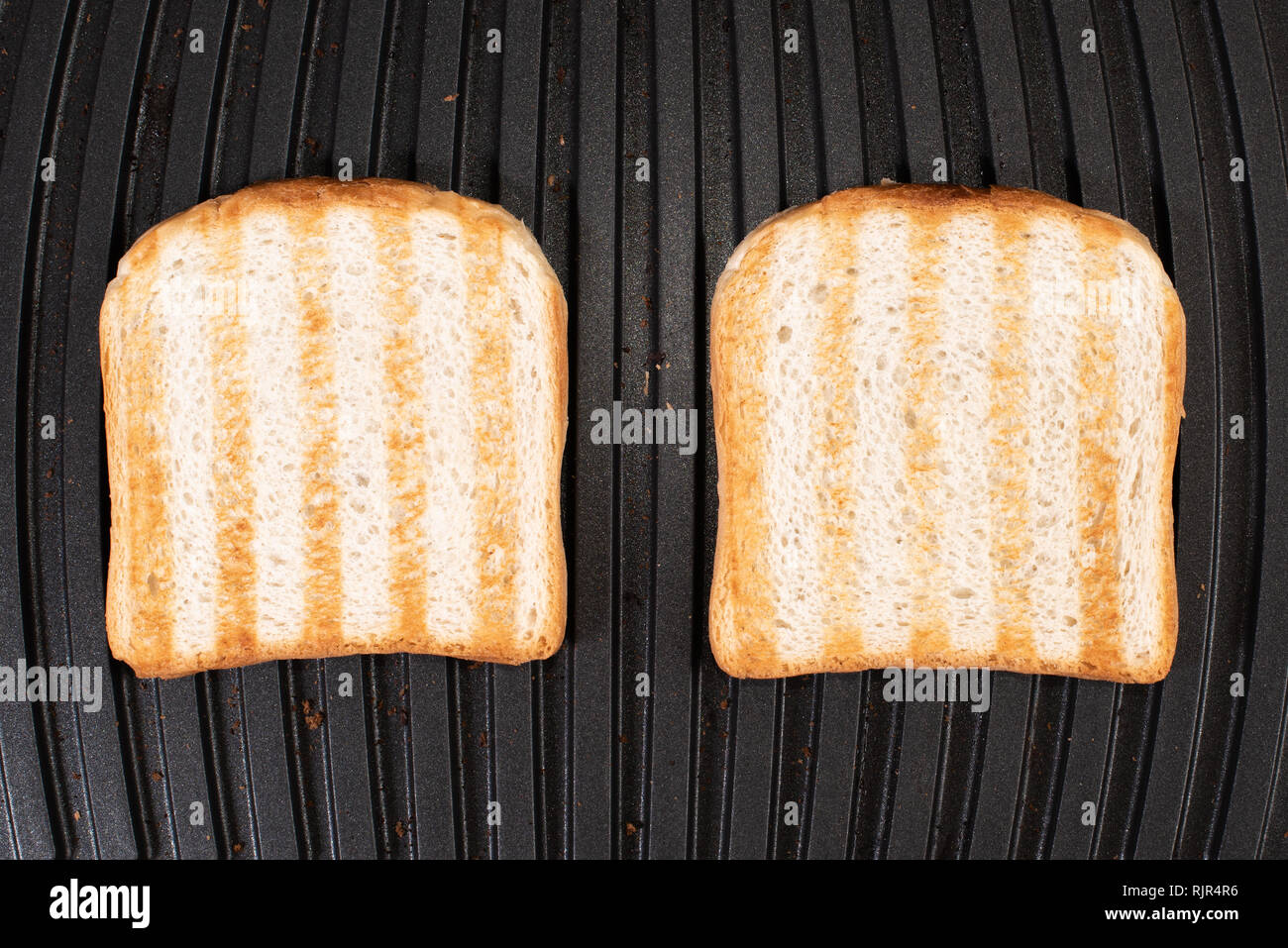 Toasted bread on the electric grill. Grilled bread Stock Photo Alamy