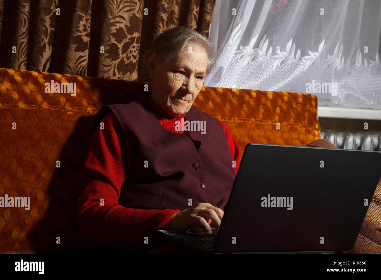 old woman using laptop Stock Photo