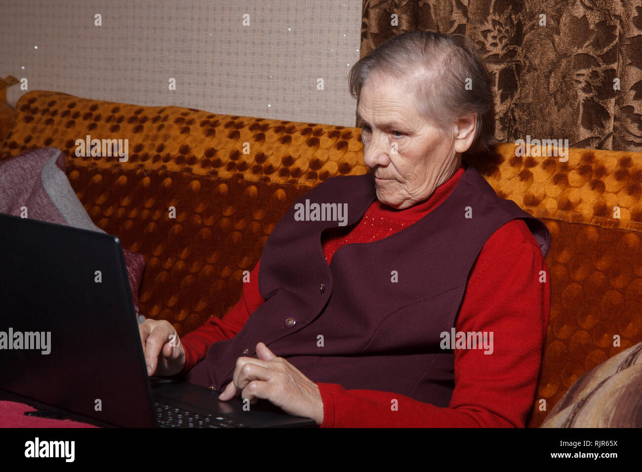 old woman using laptop Stock Photo