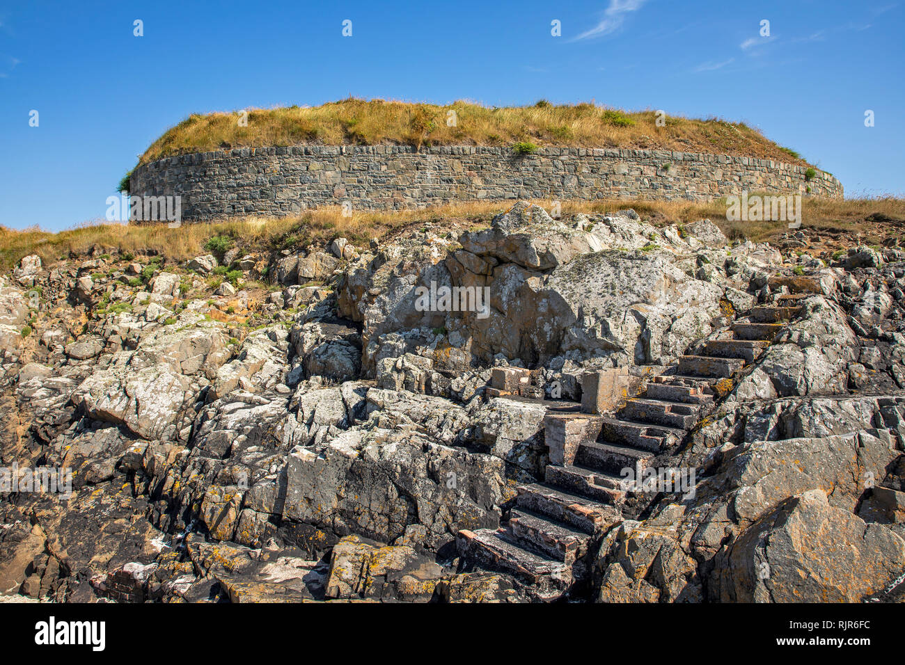 A victorian fort gun emplacment on Alderney, with hewn steps down to the nearby beach. Stock Photo