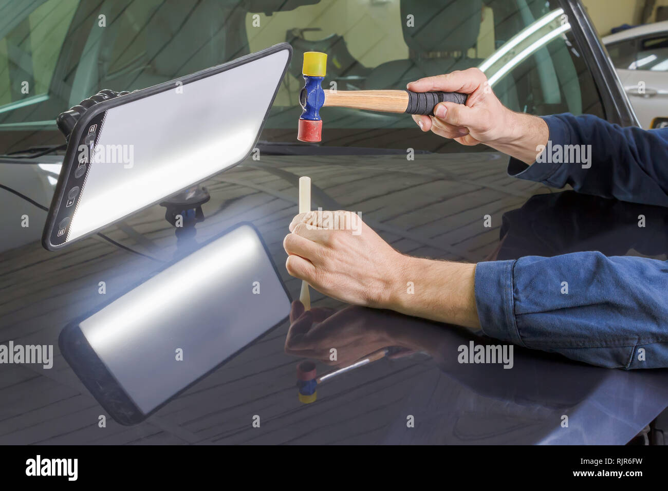 Professional Mechanic Removes Dents On The Car Body Stock Photo