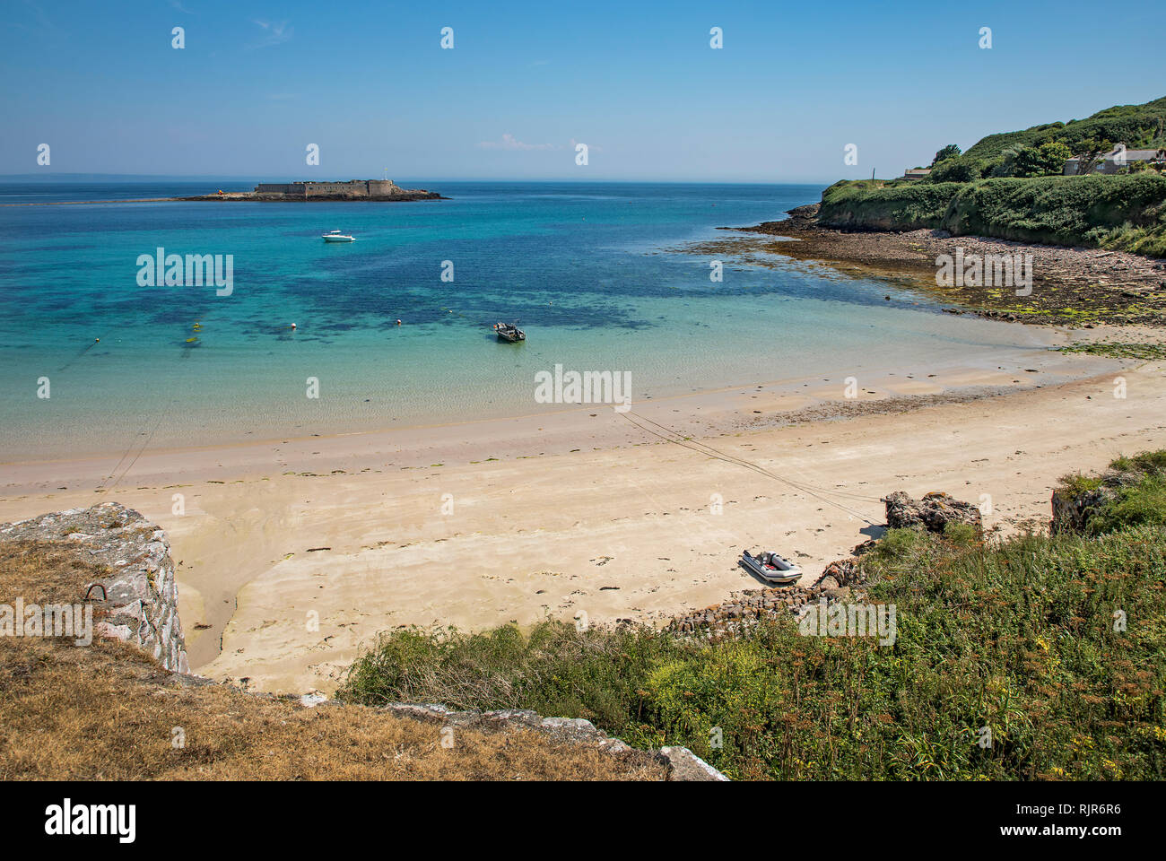 Looking south east from the Roman fort at chateau longis,Alderney, showing longis bay and the fort on Ile de Raz. Stock Photo