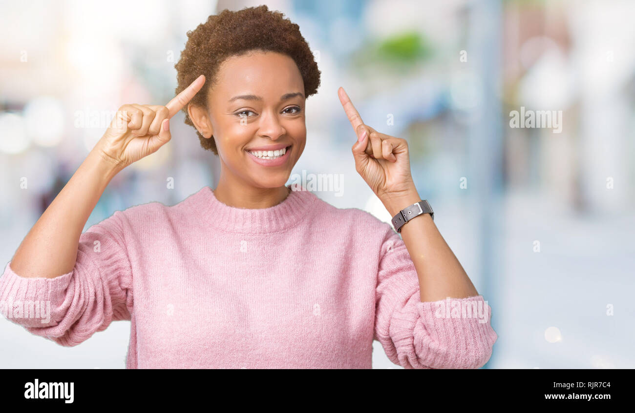 Beautiful young african american woman over isolated background Smiling pointing to head with both hands finger, great idea or thought, good memory Stock Photo