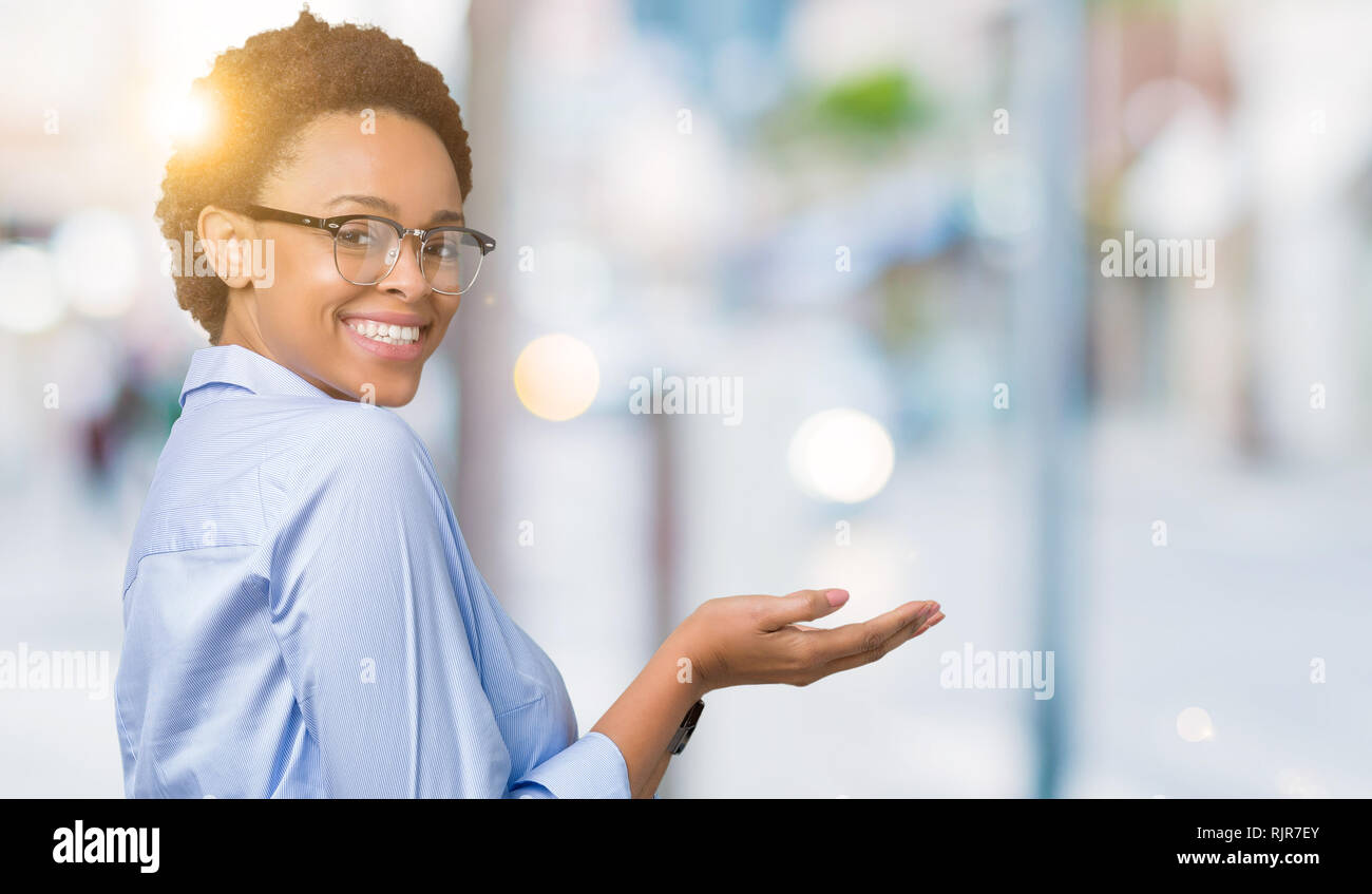 Young beautiful african american business woman over isolated ...