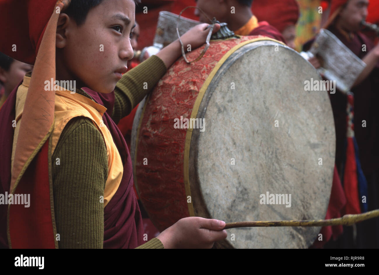 Caption Pemagantse, Sikkim, India Feb 2003. A monk hits a drum