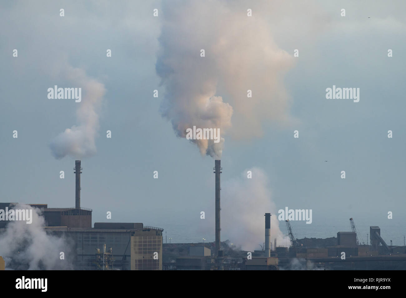 A chimney emitting fumes at Tata Steel steelworks in Port Talbot, Wales, UK. Stock Photo