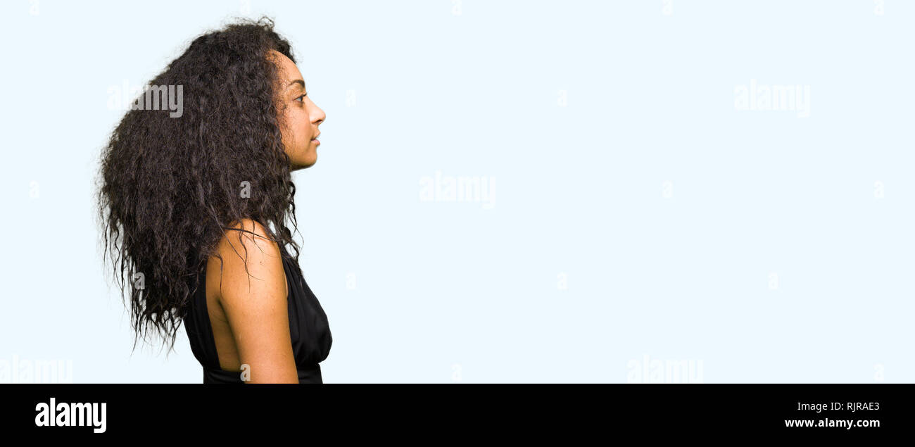 Young Beautiful Girl With Curly Hair Wearing Fashion Skirt Looking