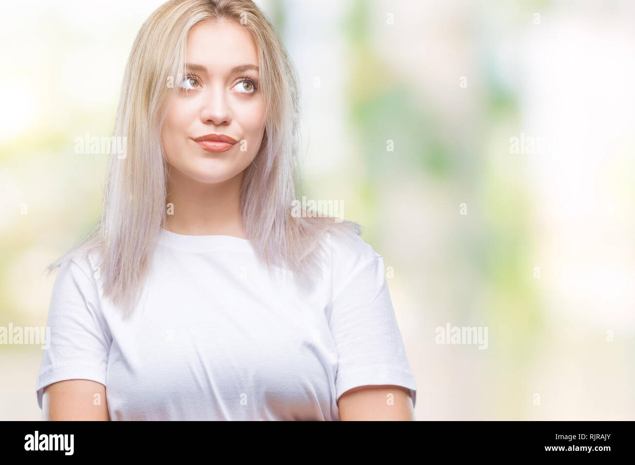 Young blonde woman over isolated background smiling looking side and ...