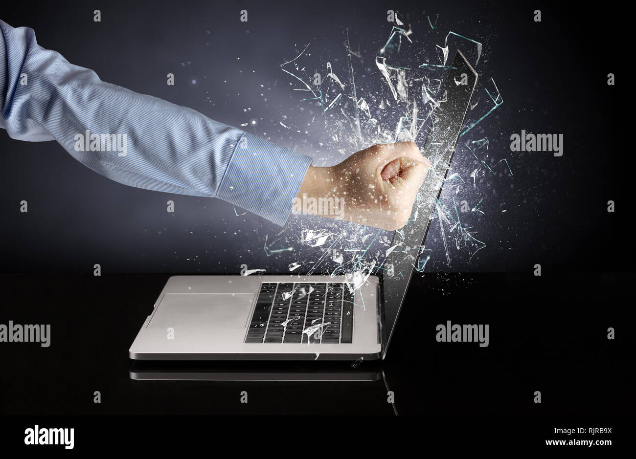 Hand hitting strongly laptop screen glass Stock Photo - Alamy