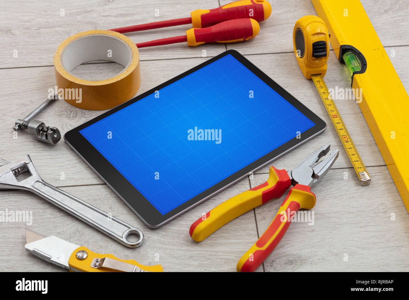 Household tools and tablet with grid screen concept Stock Photo