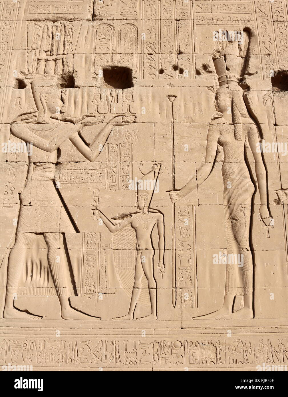 King in front of goddess; depicted on a wall relief at the Temple of Hathor, Dendera, Egypt Stock Photo