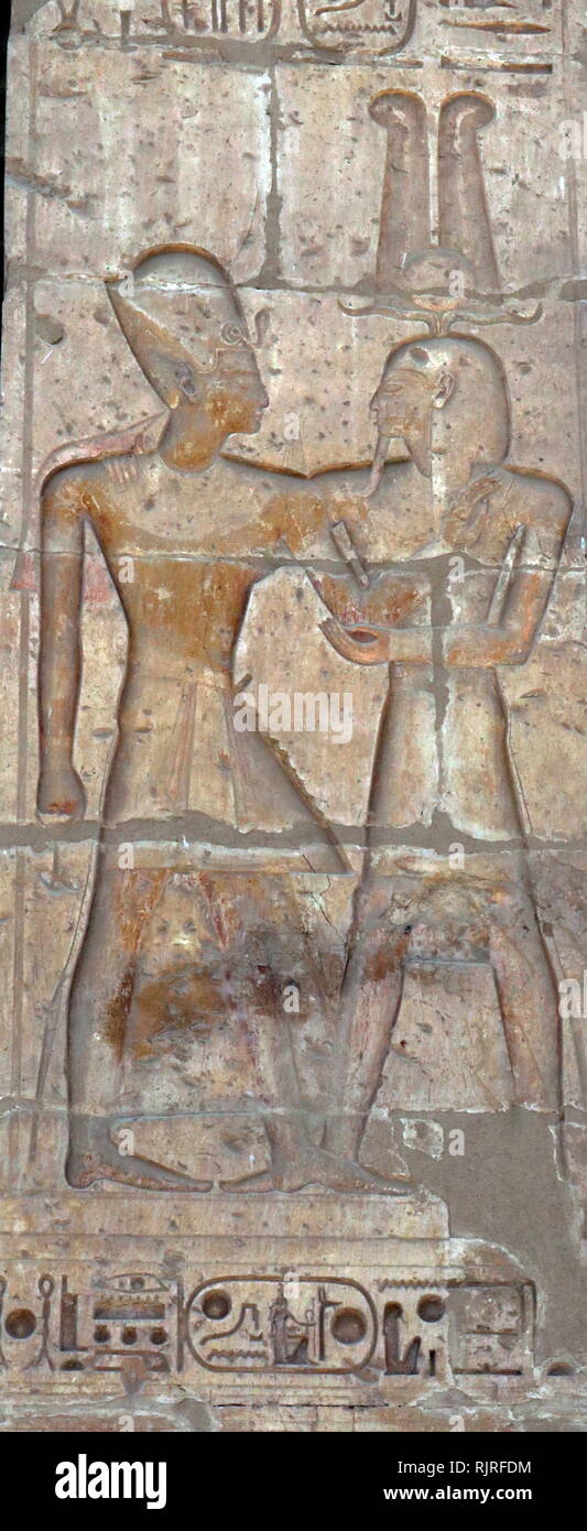Abydos, one of the oldest cities of ancient Egypt; King Rameses II blessed by god Stock Photo