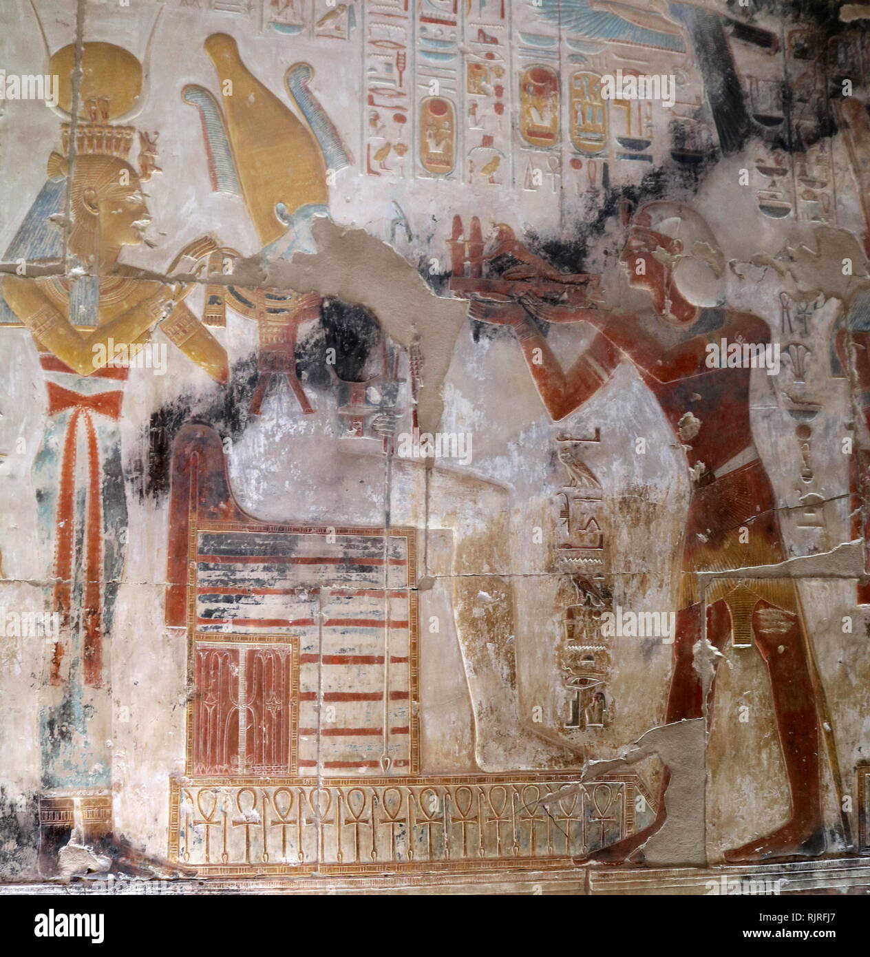 Abydos, one of the oldest cities of ancient Egypt; King Seti I, Presenting offering to Osiris and Isis Stock Photo