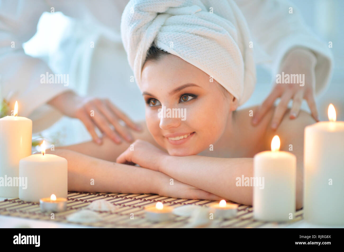 Girl lying down on a massage bed Stock Photo Alamy