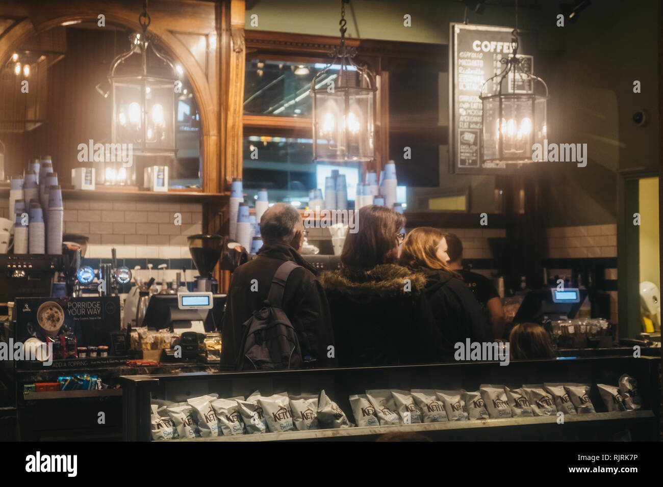 London, UK - January 26, 2019: People queuing inside Cafe Nero, a British European style coffee house brand headquartered in London, England, UK. Stock Photo