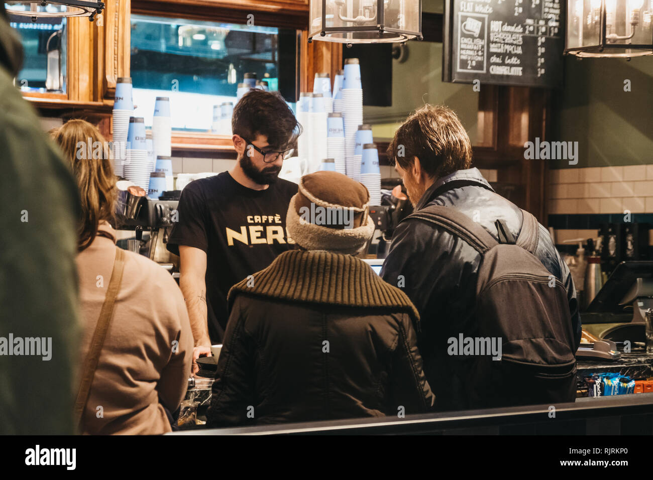 London, UK - January 26, 2019: People paying at the till inside Cafe Nero, a British European style coffee house brand headquartered in London, Englan Stock Photo