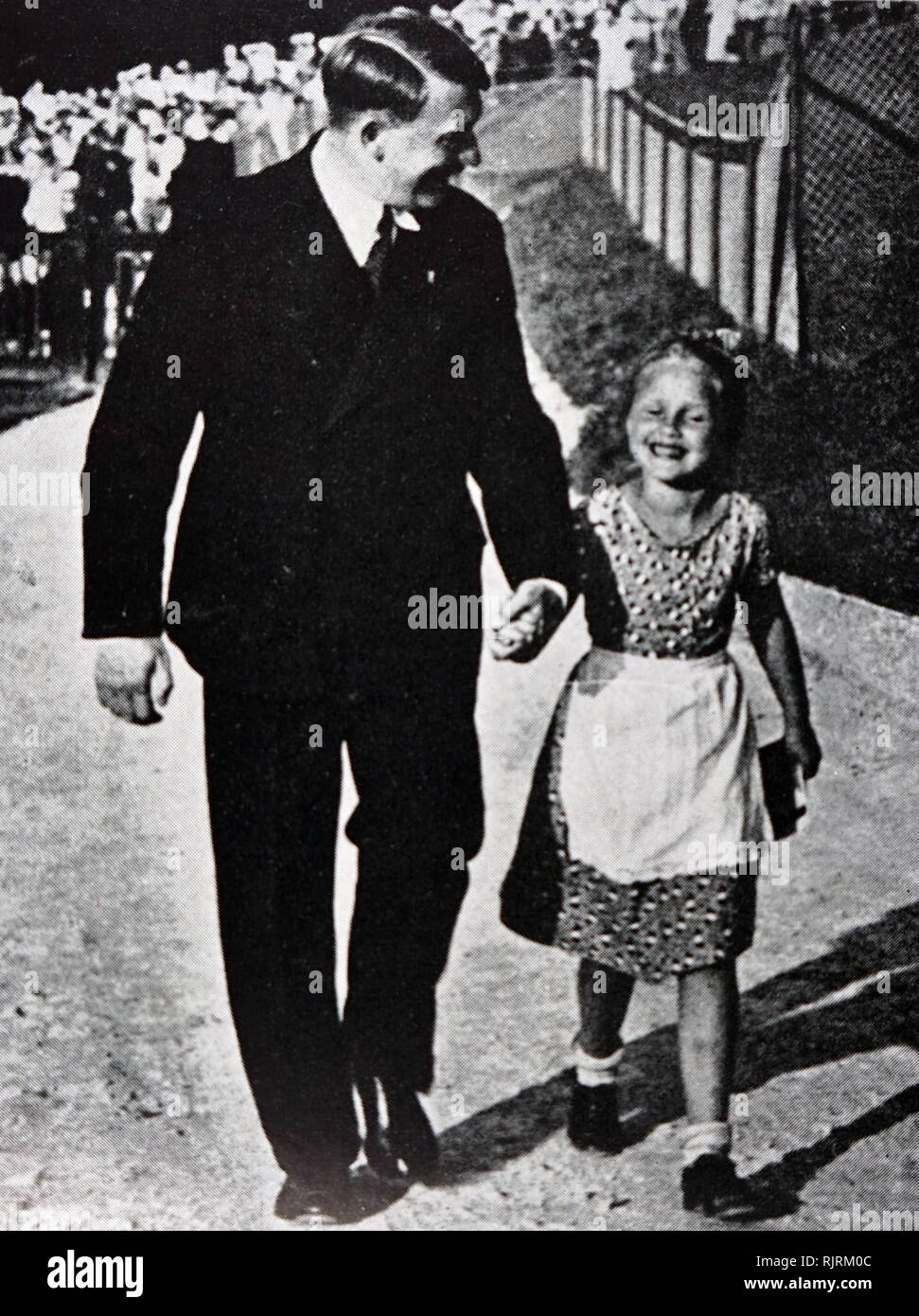 Adolf Hitler (1889 - 1945); German politician, demagogue. leader of the Nazi Party, with a typical Aryan child. Germany as Chancellor in 1933 and Fuhrer ('Leader') in 1934. dictator of Nazi Germany from 1933 to 1945, Stock Photo