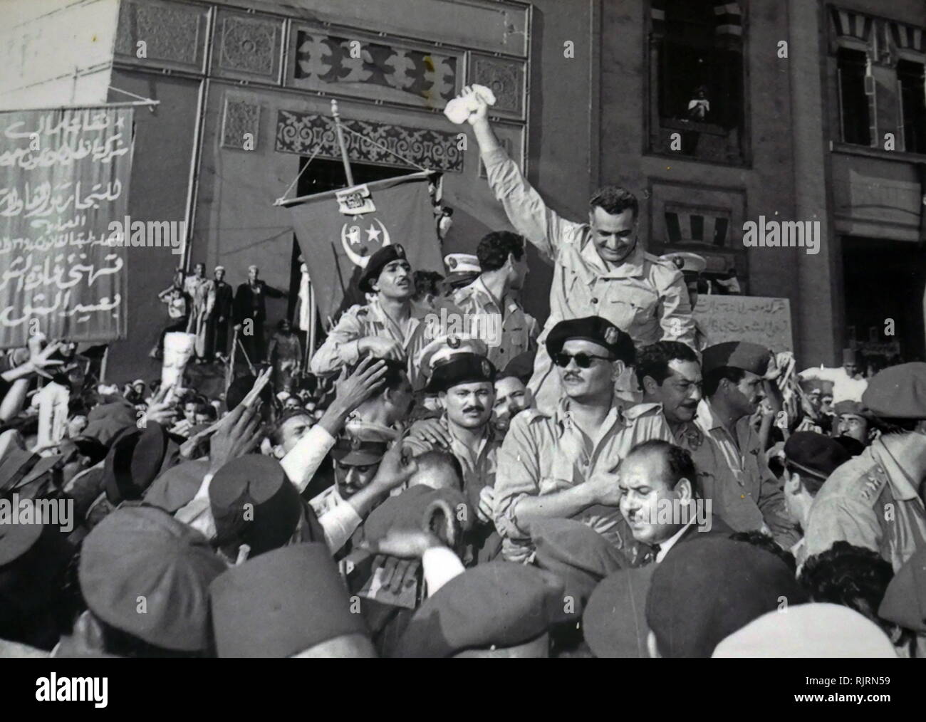 Gamal Abdel Nasser and members of the RCC, welcomed by cheering crowds in Alexandria 1954, after the signing of the British withdrawal order. (Salah Salem seated in front of Nasser with sunglasses), Kamal el-Din Husseini (behind Salem), Anwar Sadat (only partially visible, behind Husseini), Abdel Hakim Amer (standing behind Nasser, face not seen). Gamal Abdel Nasser (1918 - 1970), President of Egypt, serving from 1956 until his death in 1970. Nasser led the 1952 overthrow of the monarchy and introduced far-reaching land reforms the following year Stock Photo