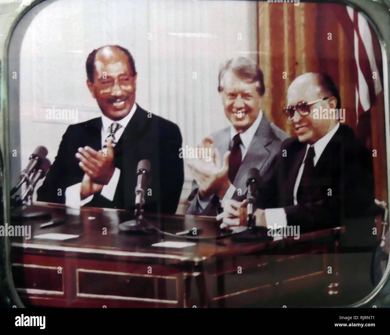 Jimmy Carter, seated with Egyptian President Anwar Sadat and Israeli Prime Minister Menachem Begin, makes statements, following the Camp David Accords. The Camp David Accords were signed by Egyptian President Anwar Sadat and Israeli Prime Minister Menachem Begin on 17 September 1978, following twelve days of secret negotiations at Camp David which in turn, led directly to the 1979 Egypt-Israel Peace Treaty. Stock Photo