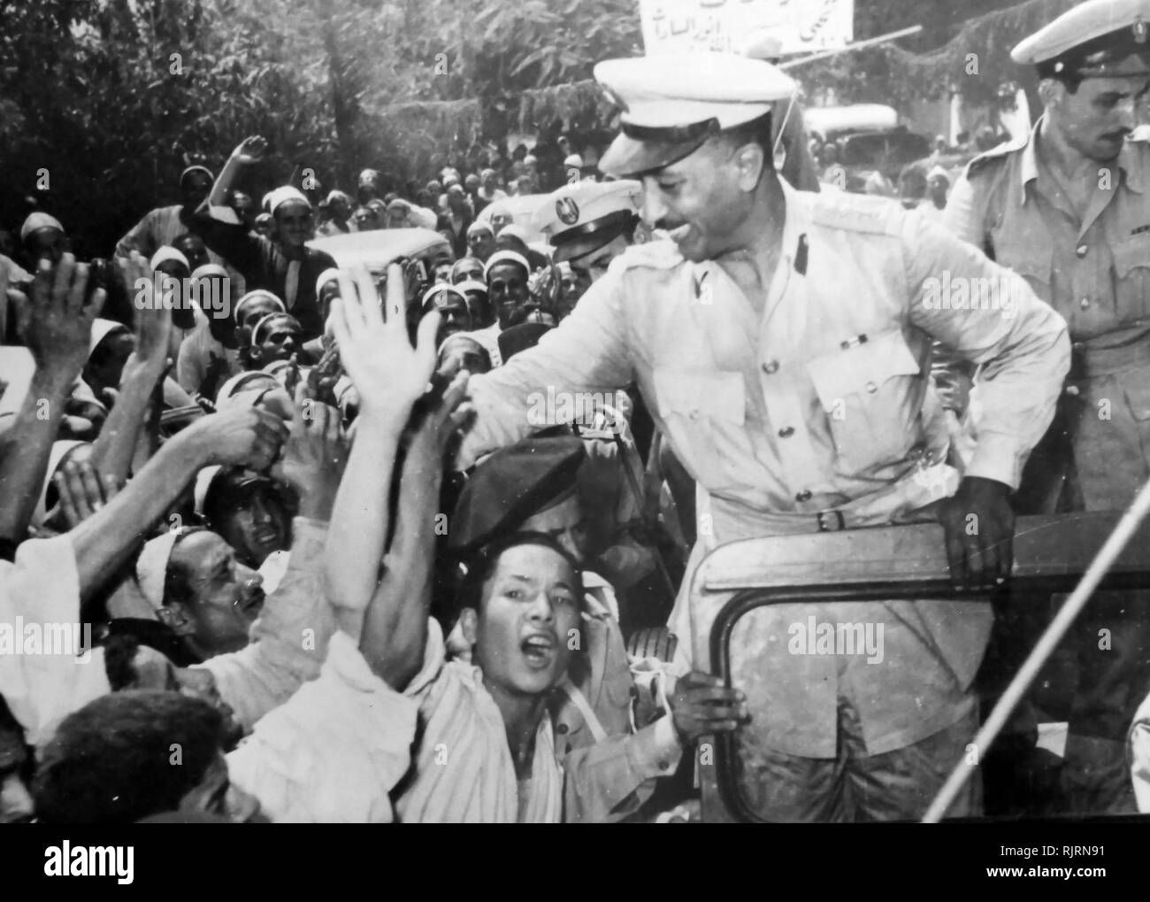 Free officers leaders including Anwar Sadat are mobbed by crowds during the 1952 Egyptian Revolution. Muhammad Anwar el-Sadat (1918 - 1981), President of Egypt, serving from 15 October 1970 until his assassination by fundamentalist army officers on 6 October 1981. Sadat was a senior member of the Free Officers who overthrew King Farouk in the Egyptian Revolution of 1952, and a close confidant of President Gamal Abdel Nasser, under whom he served as Vice President twice and whom he succeeded as President in 1970. Stock Photo