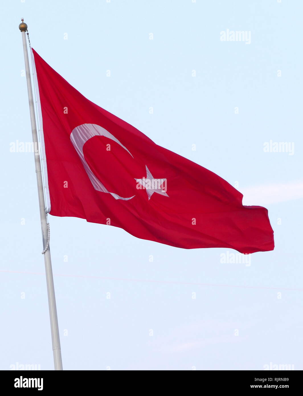 The flag of the Republic of Turkey, is a red flag featuring a white star and crescent. The flag is often called al bayrak (the red flag), and is referred to as al sancak (the red banner) in the Turkish national anthem. The current design of the Turkish flag is directly derived from the late Ottoman flag, which had been adopted in the late 18th century and acquired its final form in 1844. Stock Photo