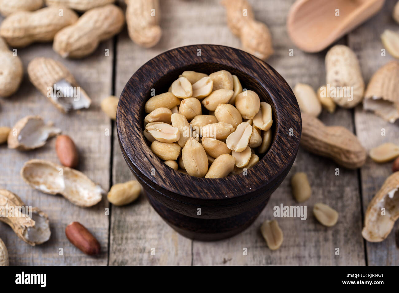 Peanuts In Small Dark Wooden Bowl On Natural Rustic Desk Stock