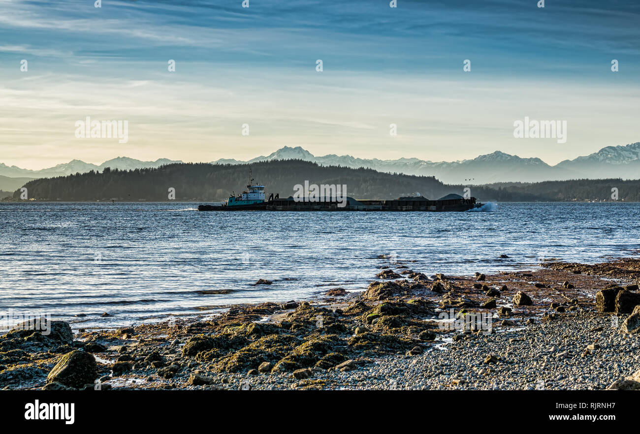A barge moves across the Puget Sound in West Seattle, Washington Stock