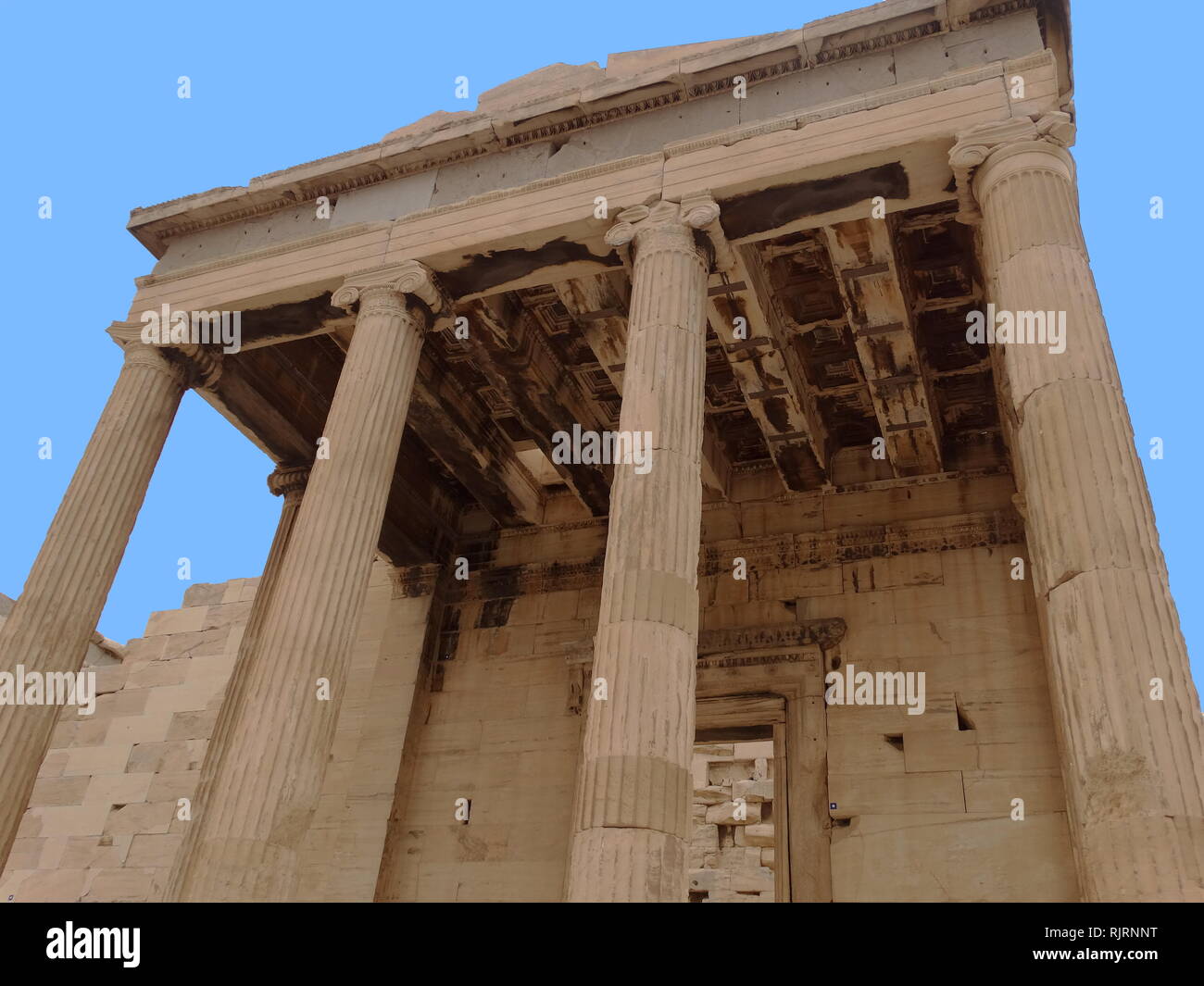 The Erechtheion; an ancient Greek temple on the Acropolis of Athens, Greece, was dedicated to both Athena and Poseidon. The temple as seen today was built between 421 and 406 BC. Its architect may have been Mnesicles, and it derived its name from a shrine dedicated to the legendary Greek hero Erichthonius. Stock Photo