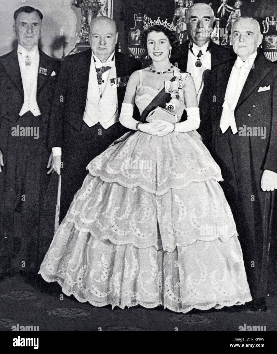 Queen Elizabeth II with Prime Ministers of the Commonwealth. 1952. She is shown here with Mr S. G. Holland (New Zealand), Sir Winston Churchill, Mr Robert Menzies (Australia) and Mir. St. Laurent (Canada).&#13;&#10; Stock Photo