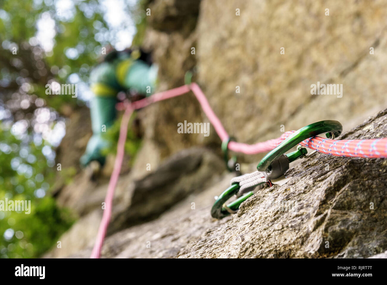 Climbing on rock with rope and quickdraw Stock Photo Alamy
