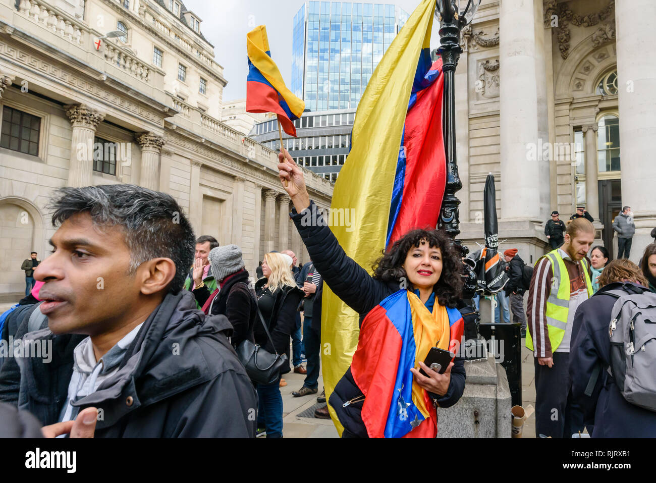 London, UK. 7th February 2019. A Venezuelan organiser waves a flag at the end of the picket organised by the Venezuela Solidarity Campaign calling on the Bank of England to return the $1.3 billion of Venezuelan gold (31 tonnes) to the Venezuelan government. Right-wing opposition leader Juan Guaido, illegitimately recognised by our government as President, has written to Theresa May calling for the funds to be sent to him.  Peter Marshall/Alamy Live News Stock Photo