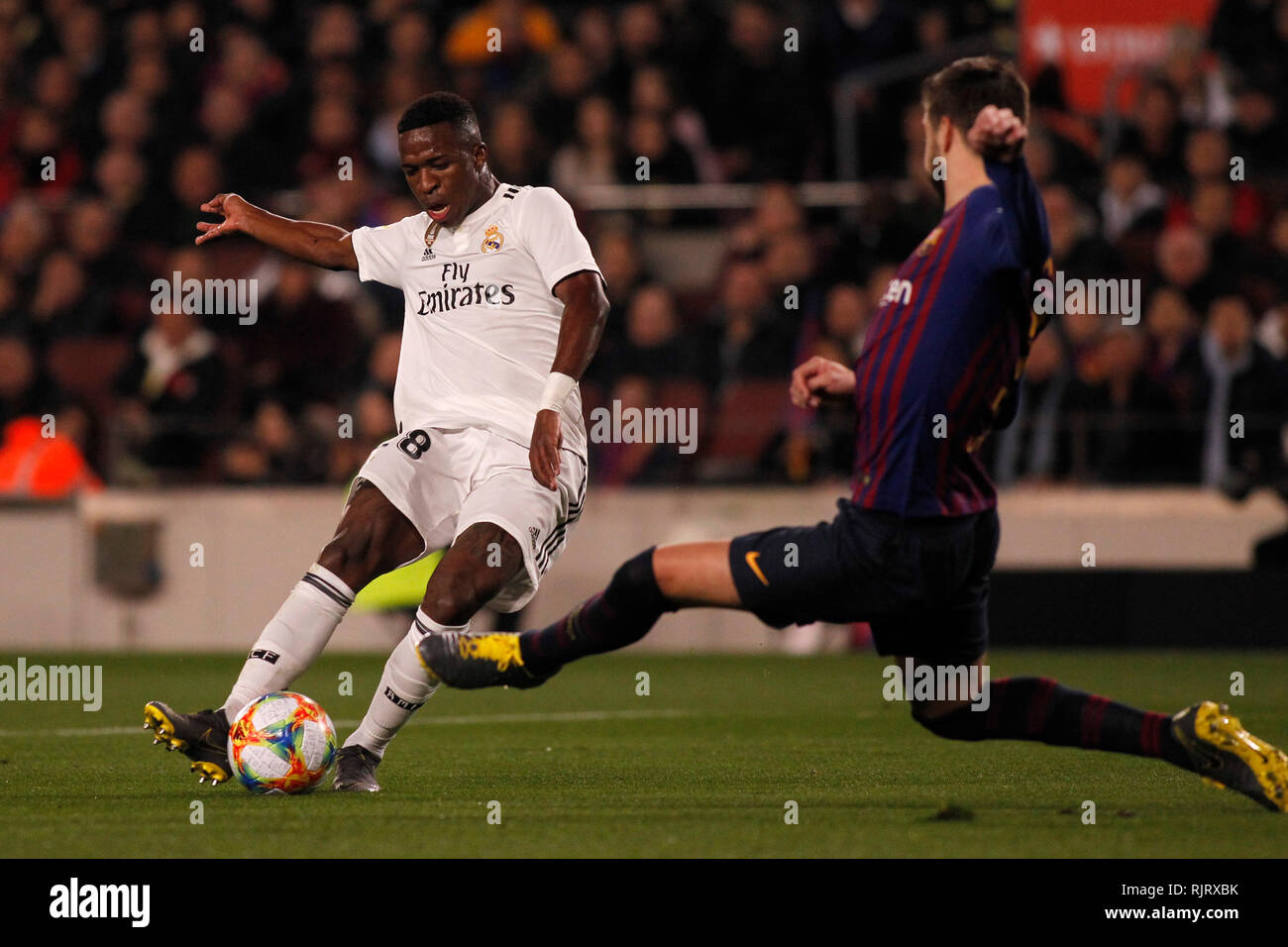 Spain La Copa, Semi finals, First Leg, FC Barcelona vs. Real Madrid, reporting live during the game -- Vinicius, Brazilian winger for Real Madrid shoots the ball in from t of Gerard Pique, spanish defender for FC Barcelona who tries to stop him Stock Photo