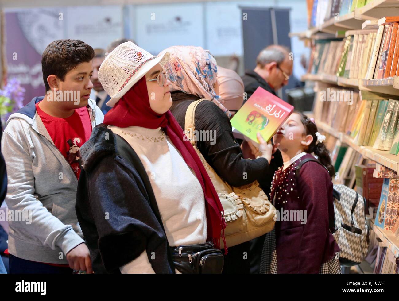 Baghdad, Iraq. 7th Feb, 2019. People select books at the Baghdad International Book Fair 2019, in Baghdad, Iraq, Feb. 7, 2019. The fair kicked off Thursday with the participation of hundreds of publishers and high attendance of readers, as it sheds more light on eradicating terror and extremism in the war-torn country. Credit: Khalil Dawood/Xinhua/Alamy Live News Stock Photo