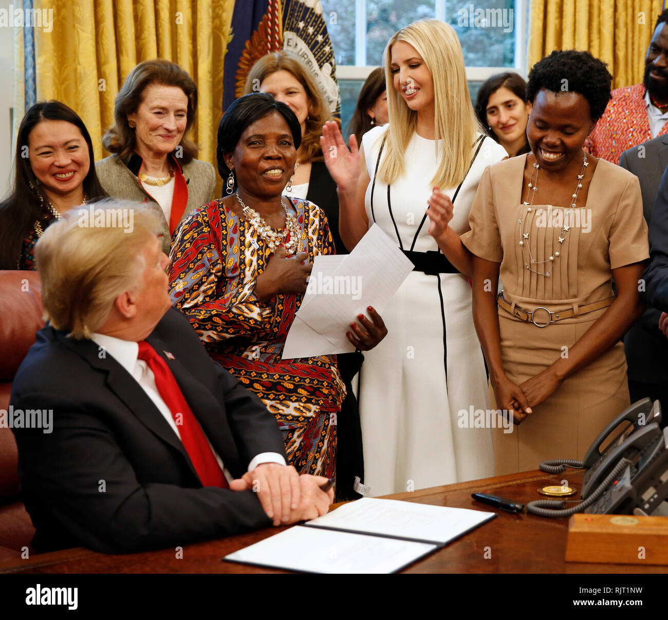 United States President Donald J Trump Listens As Ella Zande A Peace Corps Beneficiary From Malawi Makes Remarks Prior To His Signing The National Security Presidential Memorandum To Launch The Women S Global