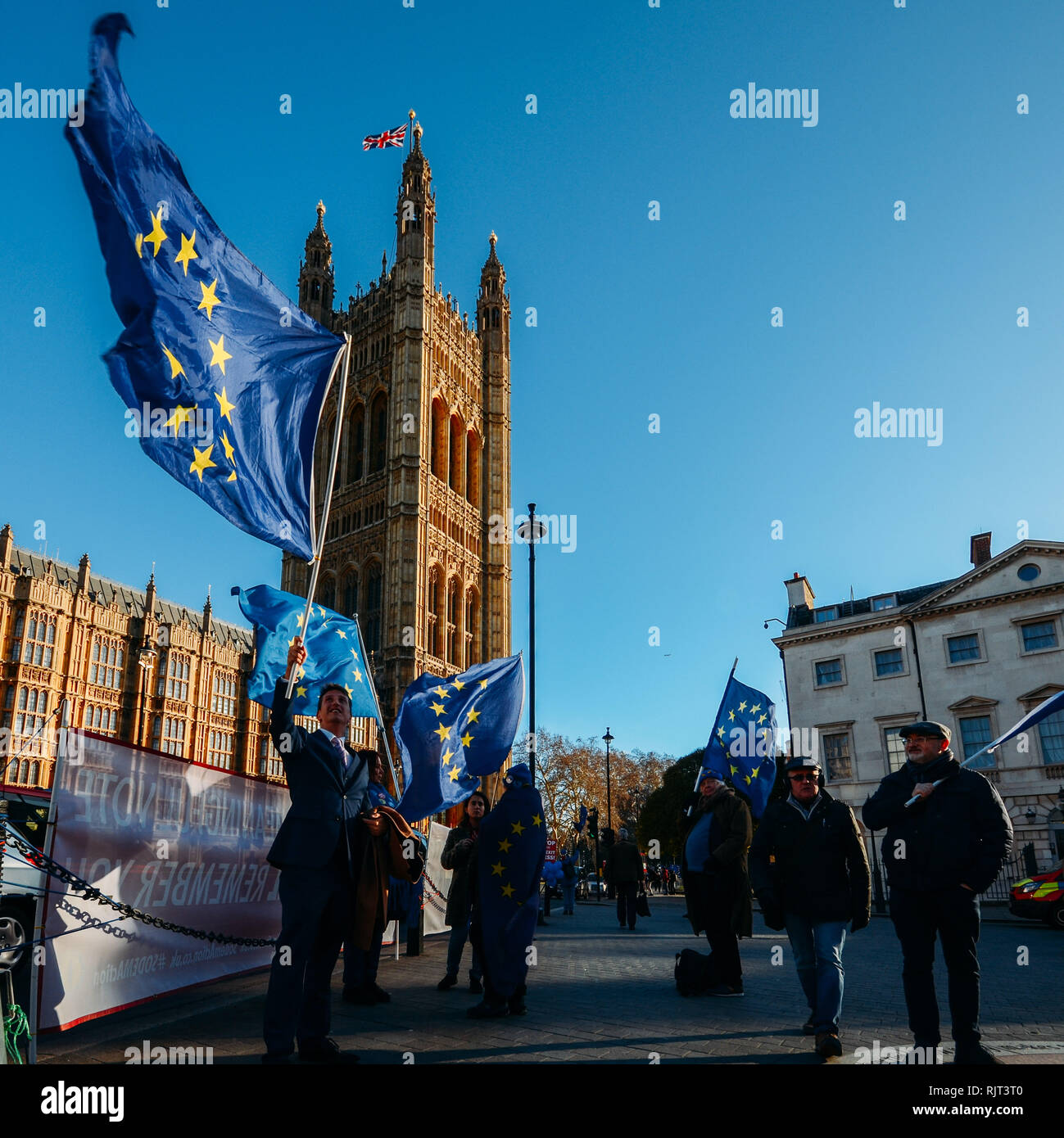London, UK - Feb 7, 2019: Anti-Brexit protester weaing a suit holds an EU flag outside Westminster, London, UK Credit: Alexandre Rotenberg/Alamy Live News Stock Photo