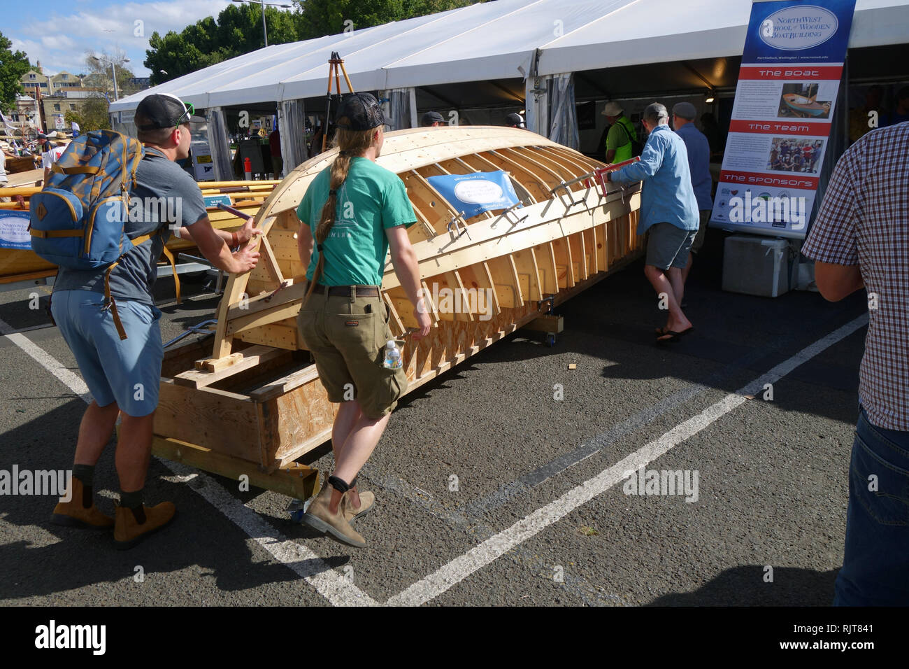 Hobart, Tasmania, Australia, 8 Feb 2019. Shipwrights and apprentices move wooden dinghy that is being hand-built during the Festival undercover in case of rain. The 2019 Australian Wooden Boat Festival celebrates historical and current shipbuilding and is one of the world’s most anticipated maritime events. Credit: Suzanne Long/Alamy Live News Stock Photo