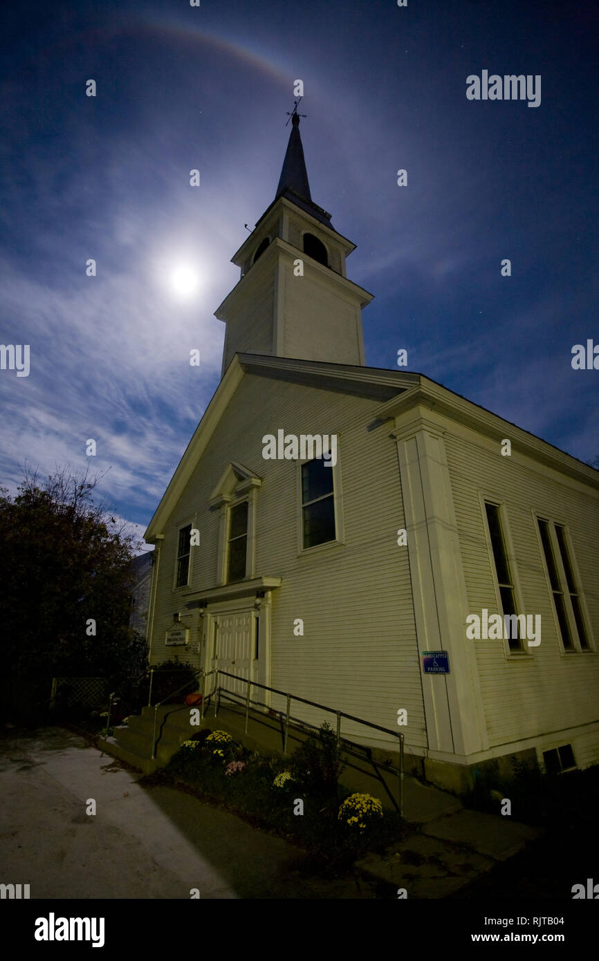 Halo around the full moon behind a historic church in Corinth, Orange County, Vermont, USA Stock Photo