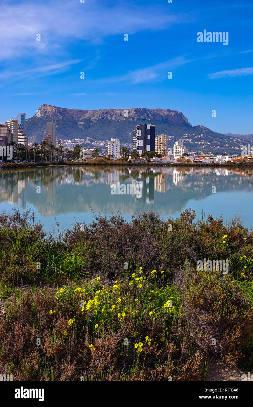 Salt-pan lagoon and tall buildings with surrounding mountains, Calpe, Valencia, Spain Stock Photo