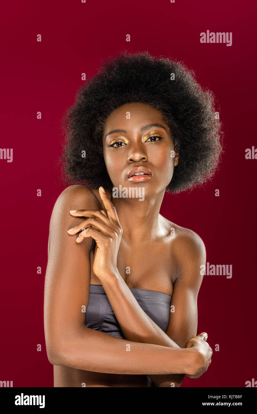 Pleasant nice young woman touching her arm Stock Photo