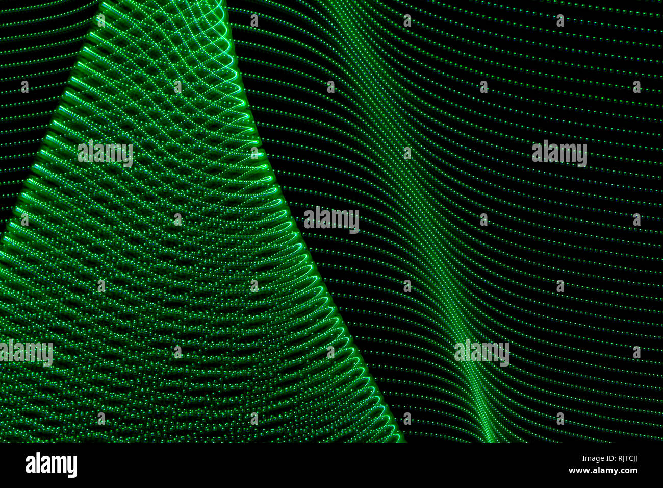 Abstract curved lines of green colors. Concept of renewable or green energy. Abstract art with lights Stock Photo