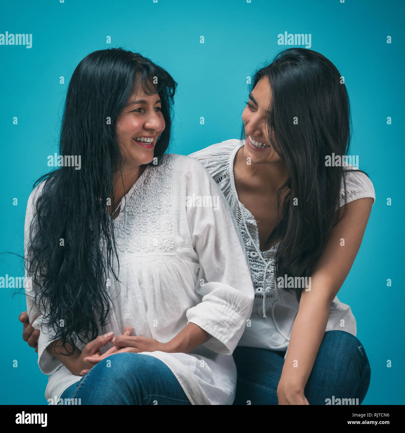 Mexican mother and daughter smiling and laughing on mothers day Stock Photo