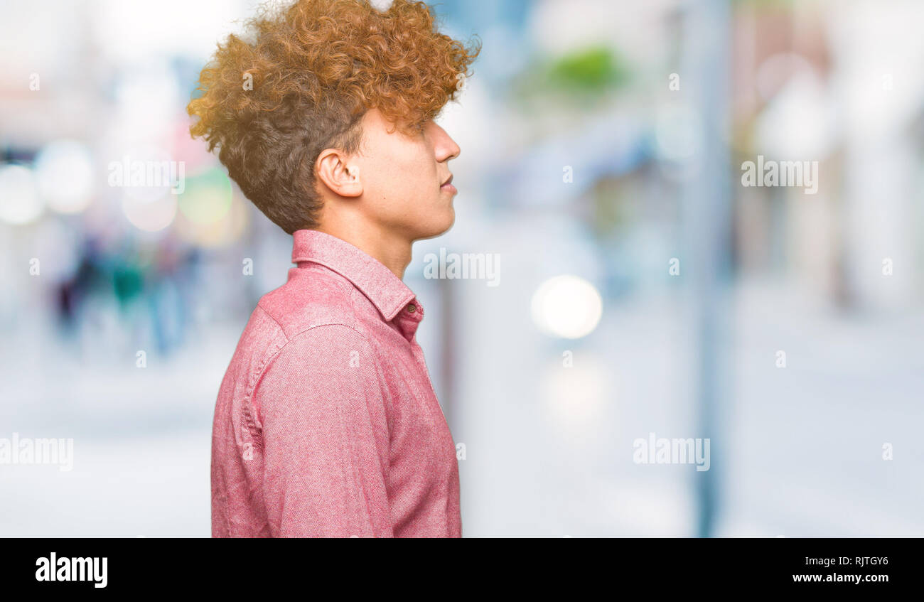 Young Handsome Business Man With Afro Hair Looking To Side Relax