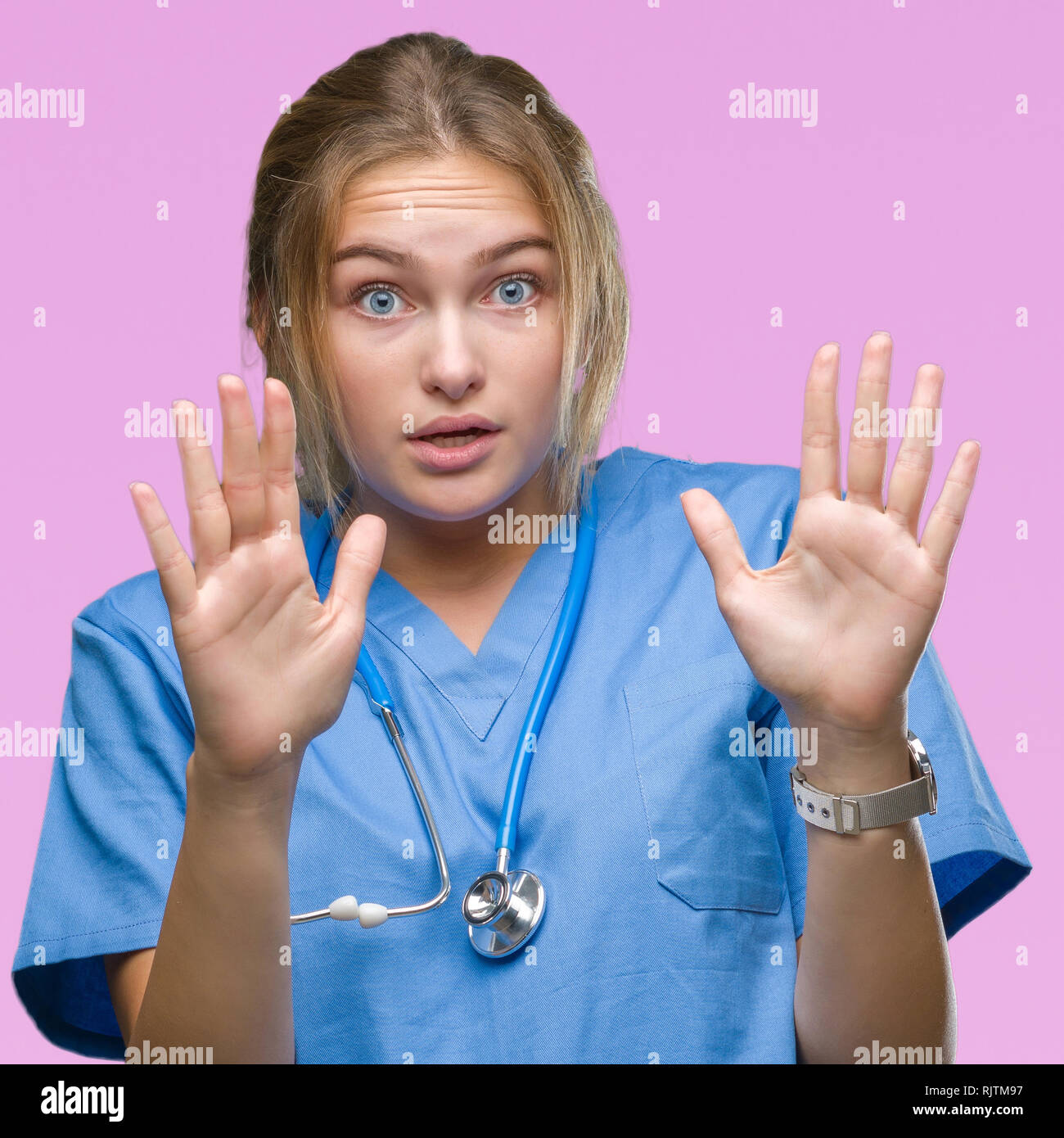 Young caucasian doctor woman wearing surgeon uniform over isolated ...