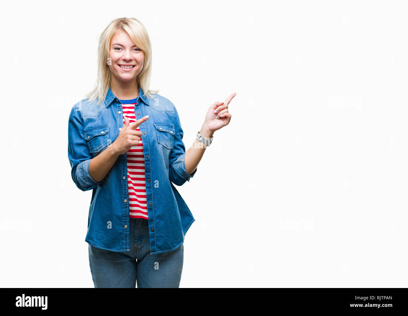 Young beautiful blonde woman wearing denim jacket over isolated background smiling and looking at the camera pointing with two hands and fingers to th Stock Photo