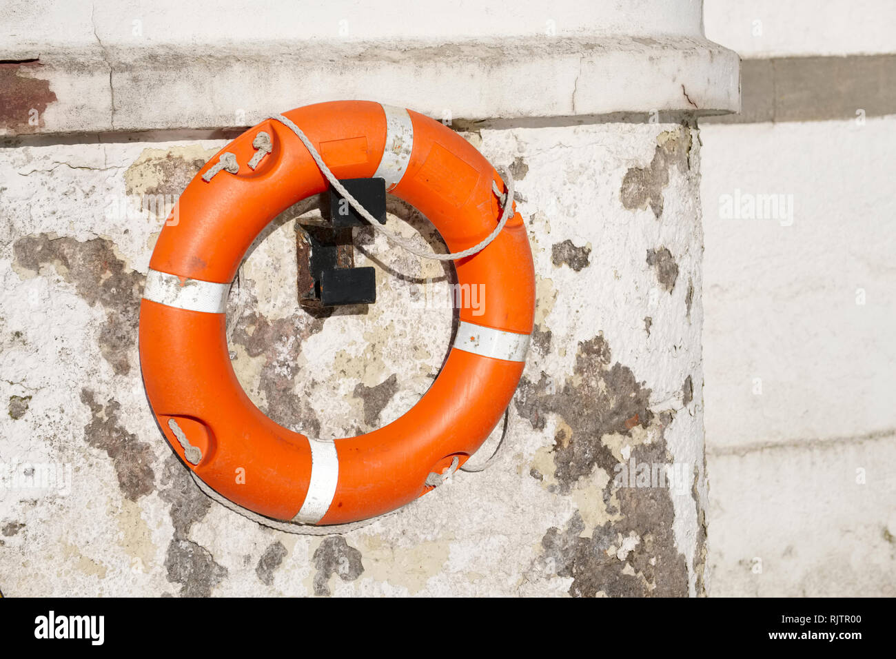 Life buoy orange ring water safety at boat mooring marina Stock Photo