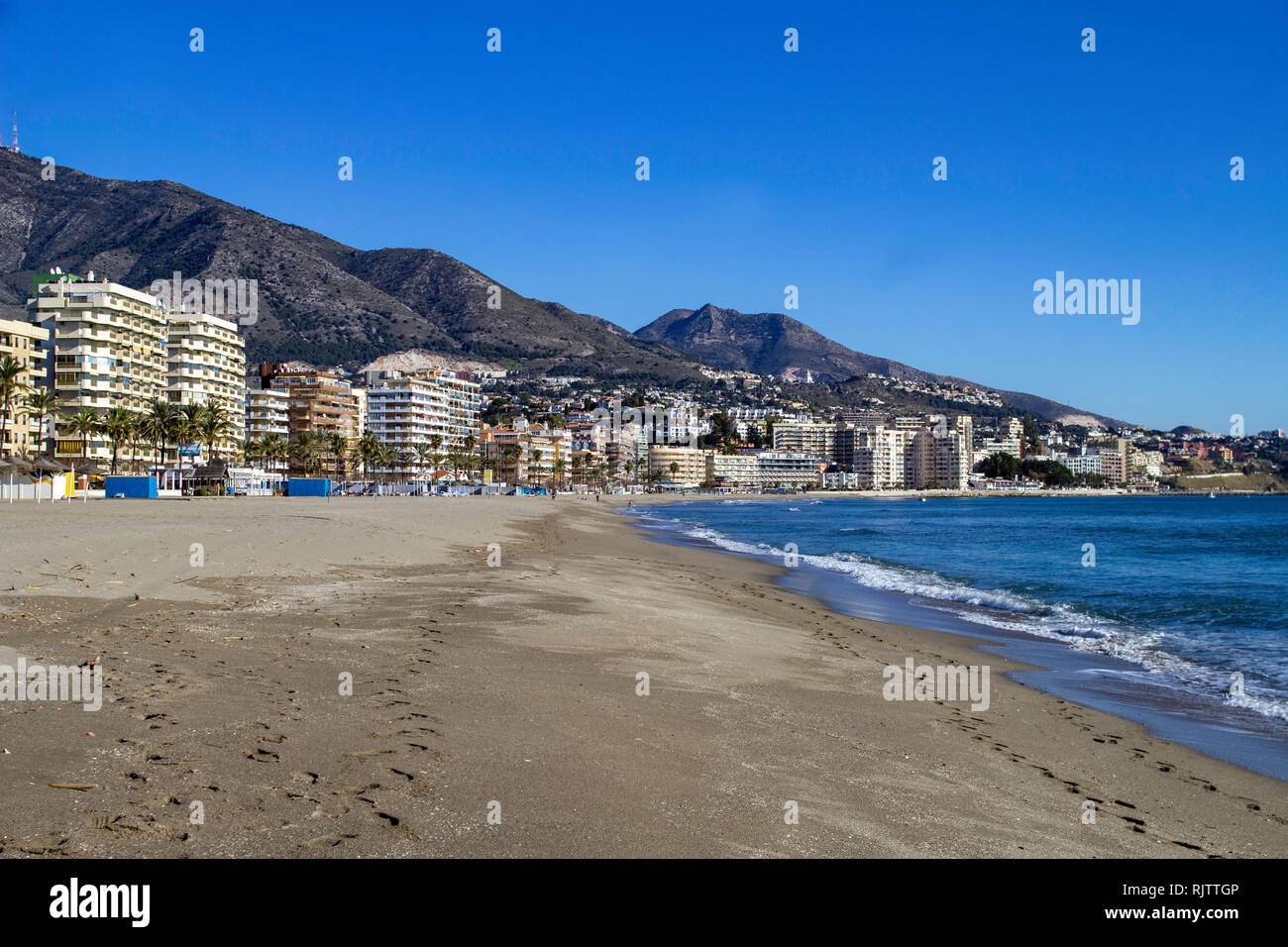 Los Boliches, Spain. The beach in Los Boliches with holiday apartments in the background. Stock Photo