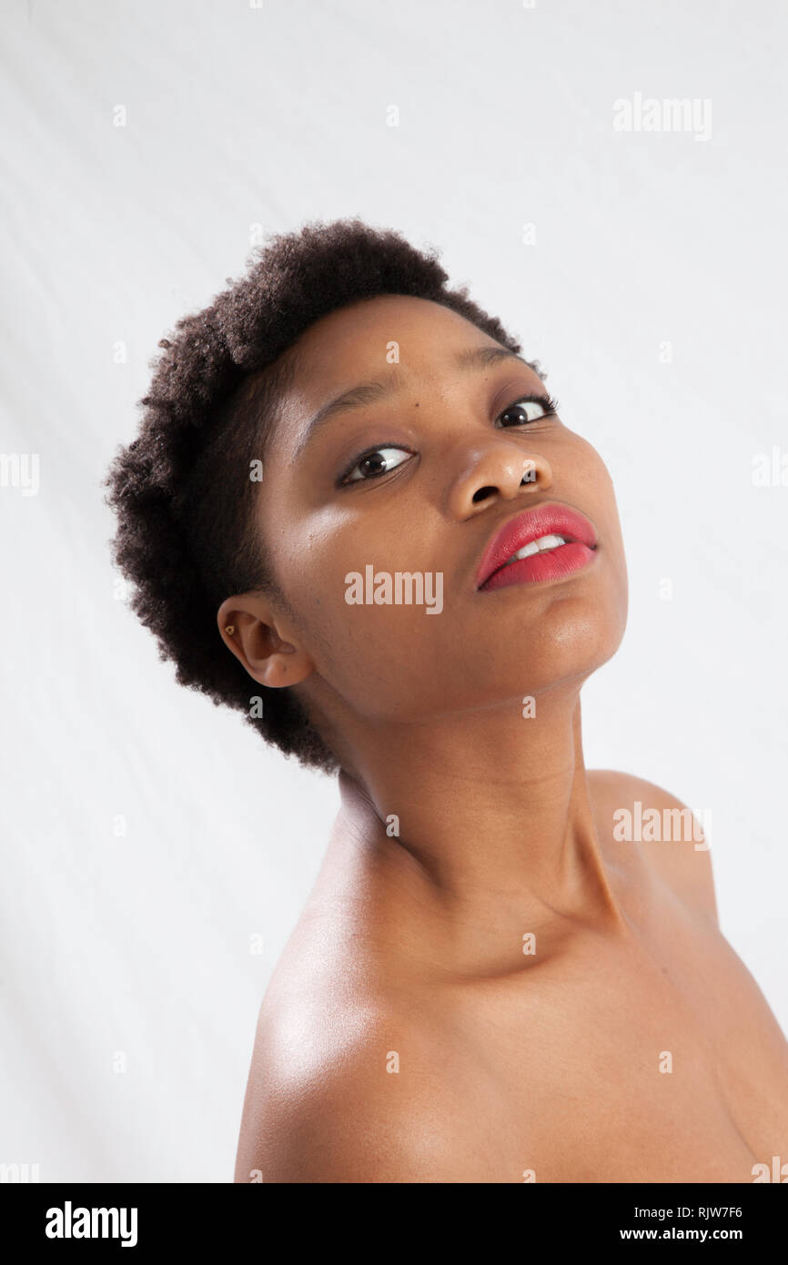 Thoughtful Black woman with her jacket off her shoulder Stock Photo - Alamy