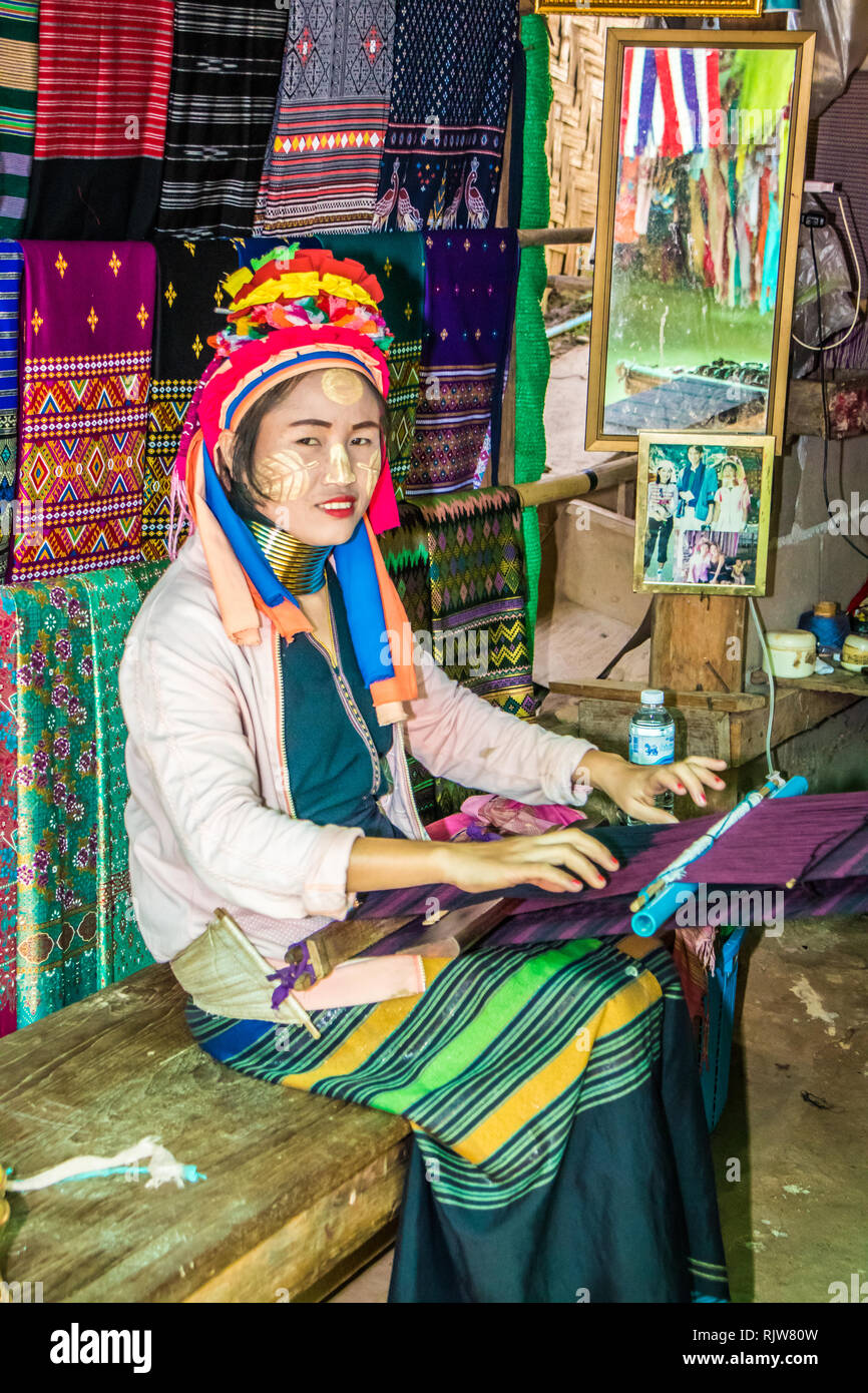 Mae Hong Son, Thailand - 7th February 2019: Karen long necked woman weaving. The first brass ring is added at the age of 5, Stock Photo